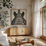 Guitar III by Deborah Revell. Shown in a natural wood frame in a cozy modern living room. Available as an archival giclee rolled canvas, fine art paper, or poster print. SKU 91250a.