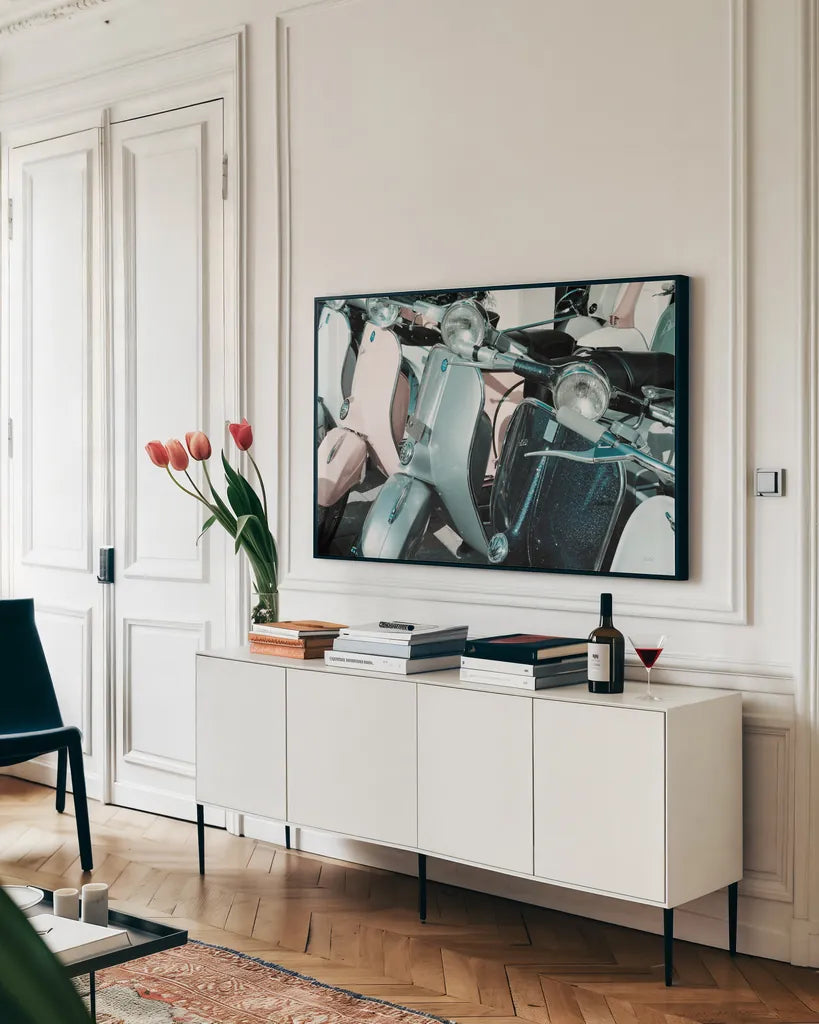 Italian Scooter III by Deborah Revell. shown as a framed stretched canvas in a living room above a console. Available as a archival giclee rolled canvas, fine art paper, or poster print. SKU 91134i.