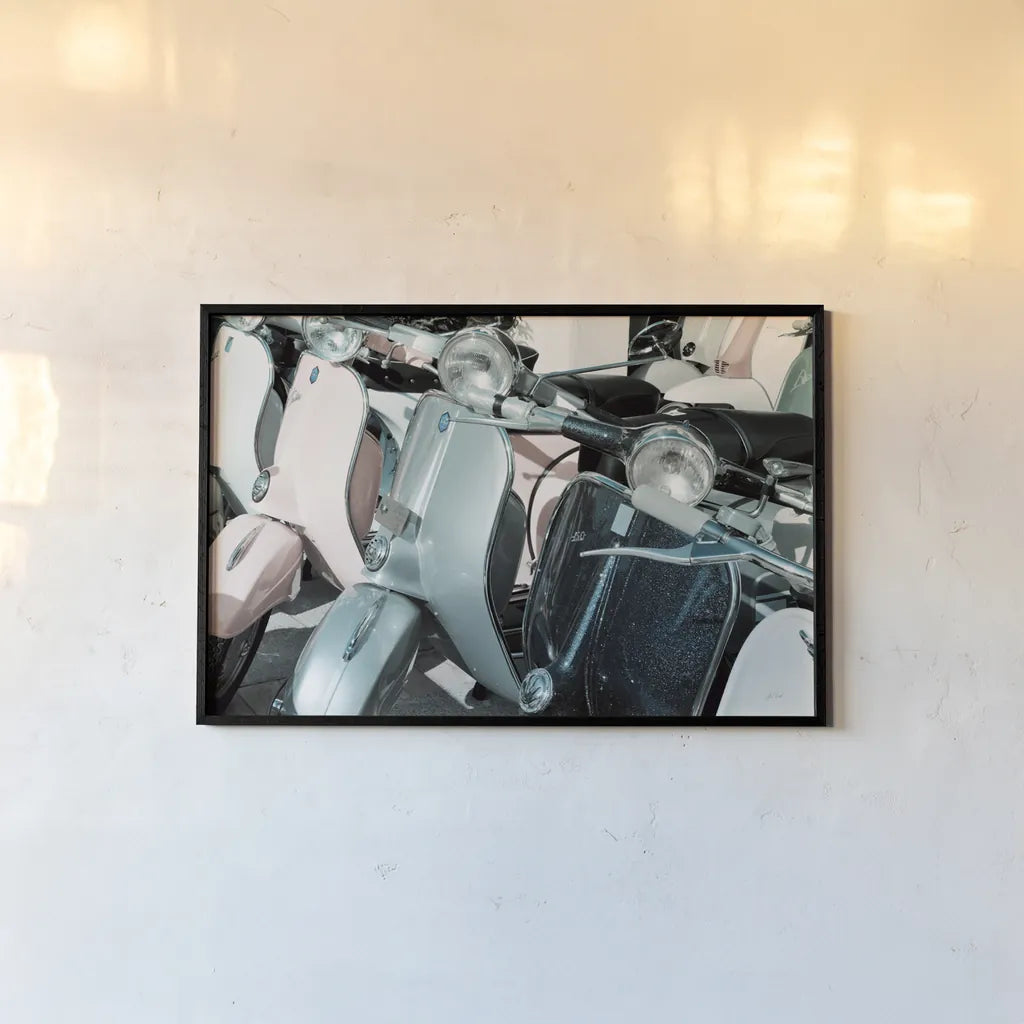 Italian Scooter III by Deborah Revell. shown as a paper print in a black flame. Available as a archival giclee rolled canvas, fine art paper, or poster print. SKU 91134i.