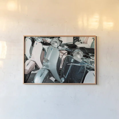 Italian Scooter III by Deborah Revell. shown as a paper print in a natural frame. Available as a archival giclee rolled canvas, fine art paper, or poster print. SKU 91134i.