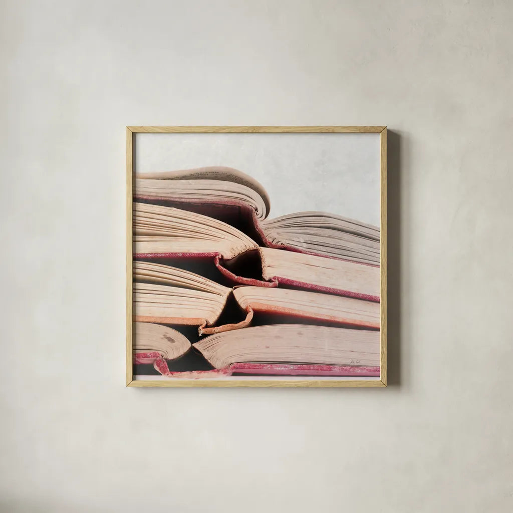 Livres Rouge by Deborah Revell. Shown in a natural wood glass frame for a timeless modern aesthetic. Available as an archival giclee rolled canvas, fine art paper, or poster print. SKU 96920a.