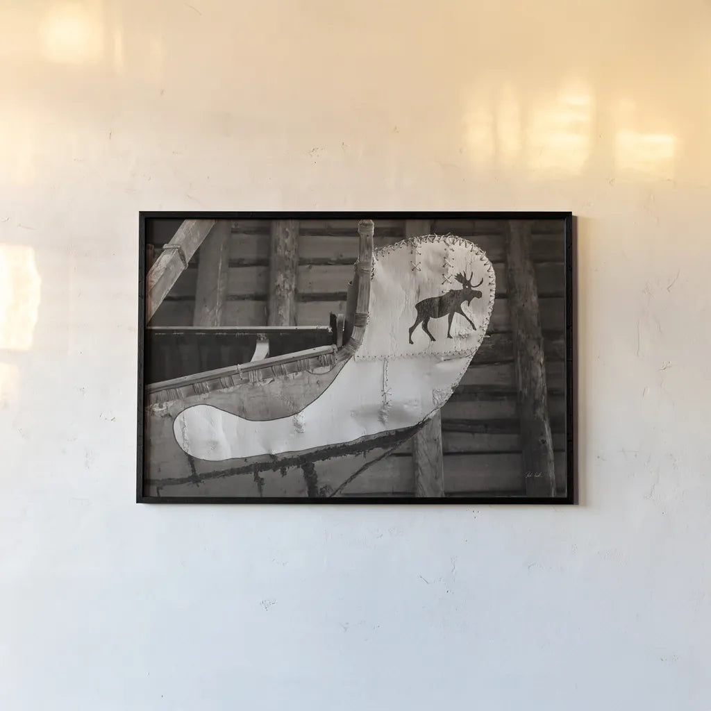 Moose Canoe by Deborah Revell. shown as a paper print in a black flame. Available as a archival giclee rolled canvas, fine art paper, or poster print. SKU 96602i.