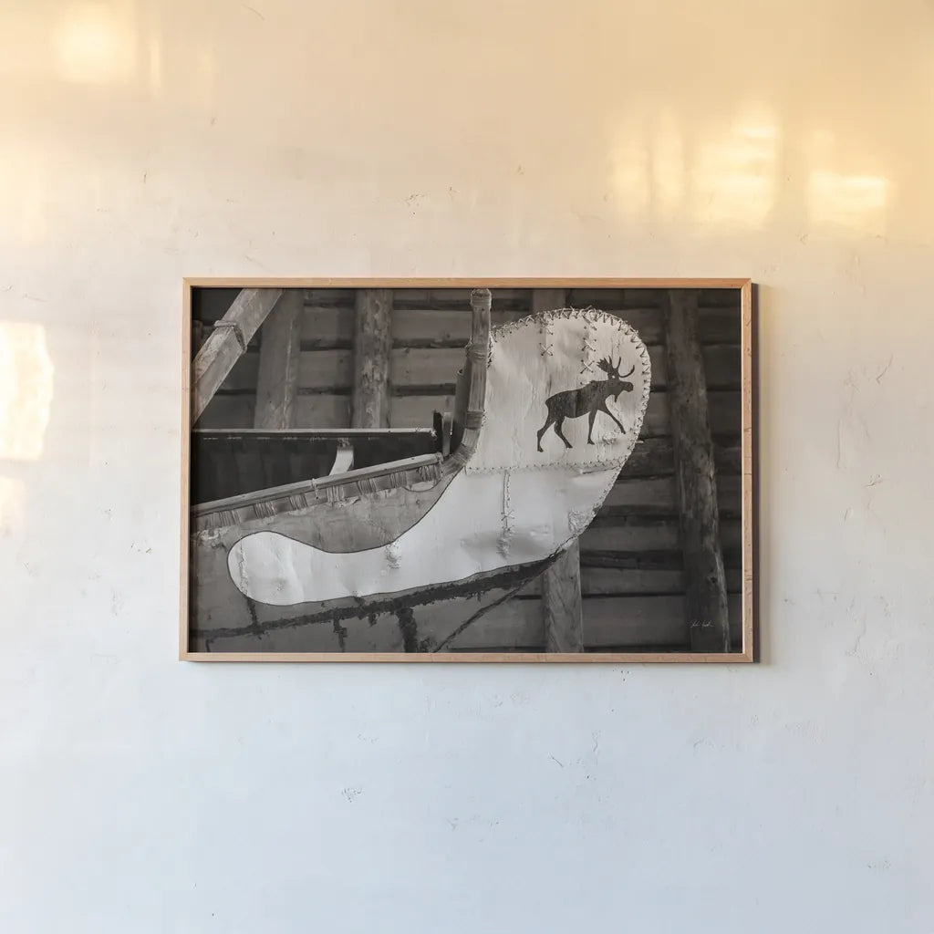 Moose Canoe by Deborah Revell. shown as a paper print in a natural frame. Available as a archival giclee rolled canvas, fine art paper, or poster print. SKU 96602i.