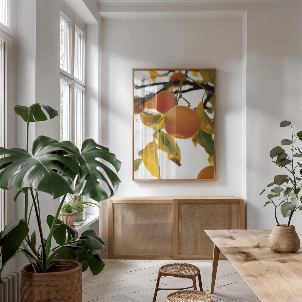 Oranges II by Deborah Revell. shown as a print in a natural wood frame in a dining room. Available as a archival giclee rolled canvas, fine art paper, or poster print. SKU 94129h.