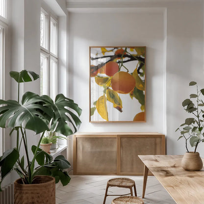 Oranges II by Deborah Revell. shown as a print in a natural wood frame in a dining room. Available as a archival giclee rolled canvas, fine art paper, or poster print. SKU 94129h.