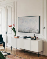 Over the Hedge by Deborah Revell. shown as a framed stretched canvas in a living room above a console. Available as a archival giclee rolled canvas, fine art paper, or poster print. SKU 93442i.