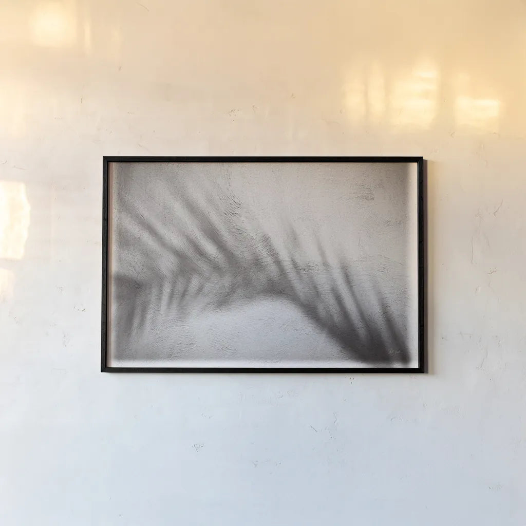 Palm Shadow Afternoon II by Deborah Revell. shown as a paper print in a black flame. Available as a archival giclee rolled canvas, fine art paper, or poster print. SKU 94353i.