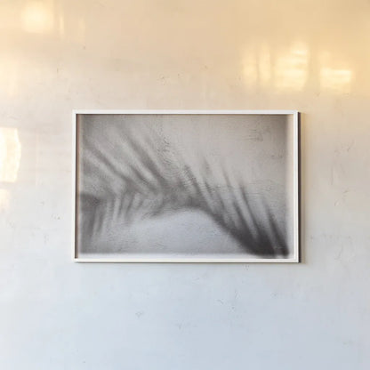 Palm Shadow Afternoon II by Deborah Revell. shown as a paper print in a white frame. Available as a archival giclee rolled canvas, fine art paper, or poster print. SKU 94353i.