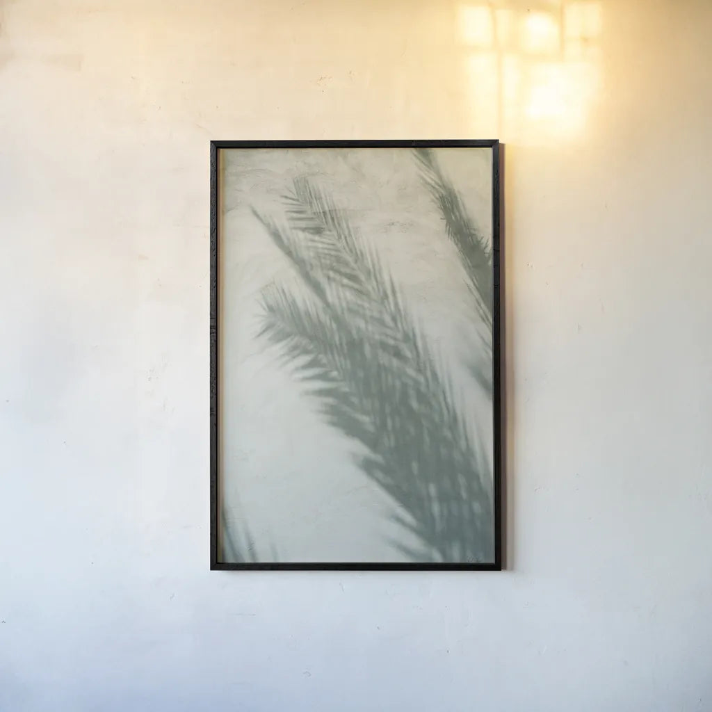 Palm Shadow I by Deborah Revell. shown as a paper print in a black flame. Available as a archival giclee rolled canvas, fine art paper, or poster print. SKU 94354h.