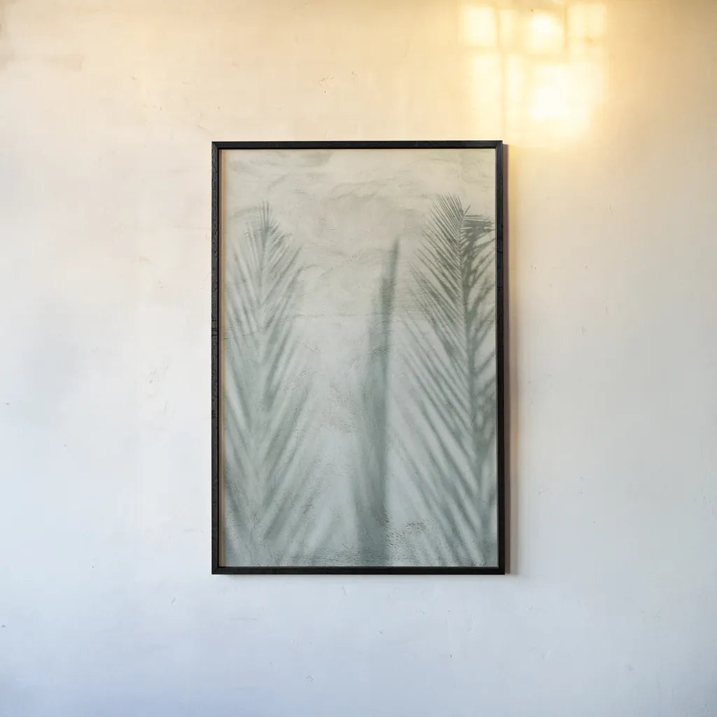 Palm Shadow II by Deborah Revell. shown as a paper print in a black flame. Available as a archival giclee rolled canvas, fine art paper, or poster print. SKU 94355h.