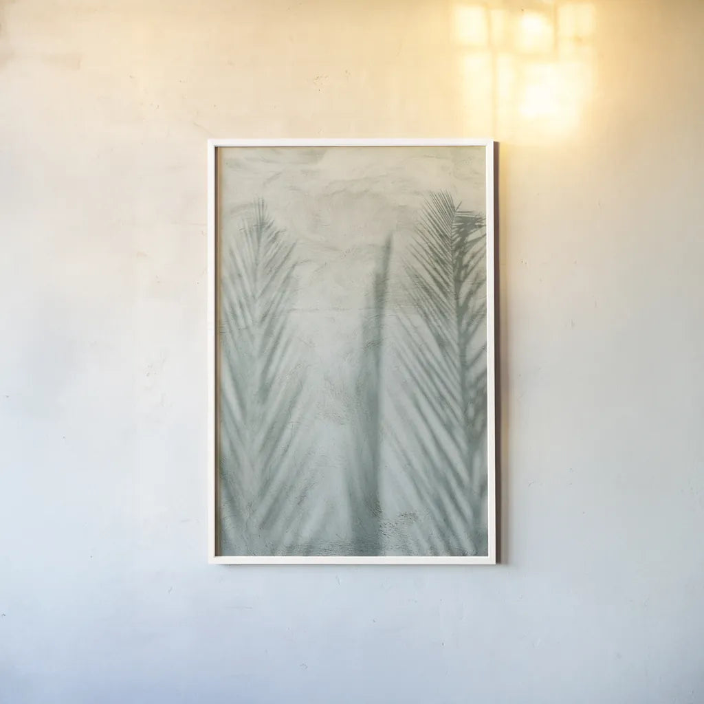 Palm Shadow II by Deborah Revell. shown as a paper print in a white frame. Available as a archival giclee rolled canvas, fine art paper, or poster print. SKU 94355h.