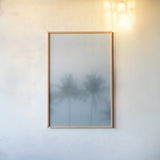 Palms in the Mist I by Deborah Revell. shown as a paper print in a natural frame. Available as a archival giclee rolled canvas, fine art paper, or poster print. SKU 104906h.