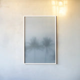 Palms in the Mist I by Deborah Revell. shown as a paper print in a white frame. Available as a archival giclee rolled canvas, fine art paper, or poster print. SKU 104906h.