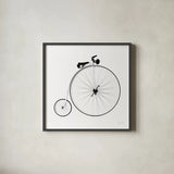 Penny Farthing by Deborah Revell. Shown in a sleek black glass frame for a contemporary gallery look. Available as an archival giclee rolled canvas, fine art paper, or poster print. SKU 92265a.