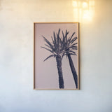 Pink Palms I by Deborah Revell. shown as a paper print in a natural frame. Available as a archival giclee rolled canvas, fine art paper, or poster print. SKU 94375h.