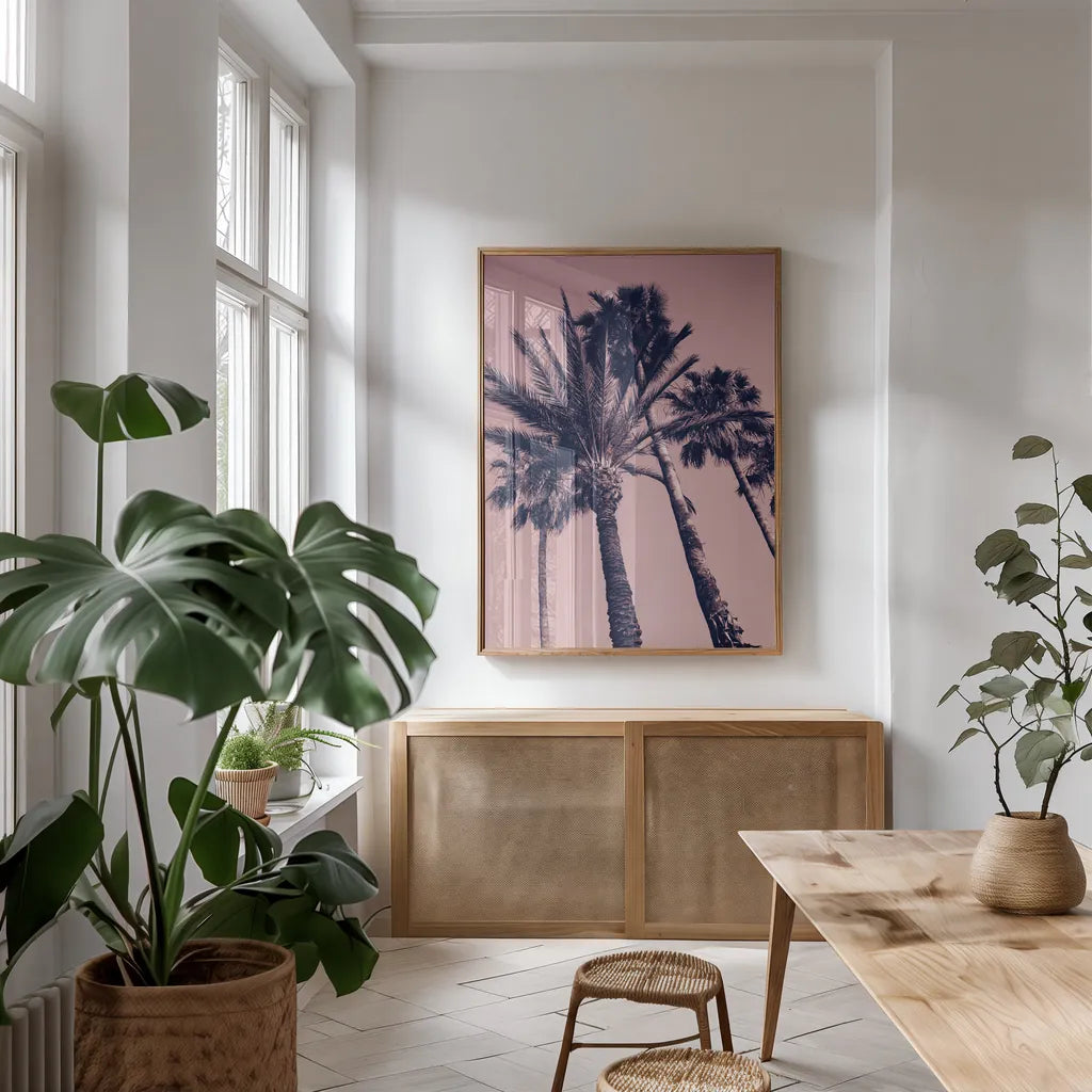 Pink Palms II by Deborah Revell. shown as a print in a natural wood frame in a dining room. Available as a archival giclee rolled canvas, fine art paper, or poster print. SKU 94376h.