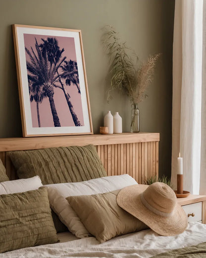 Pink Palms II by Deborah Revell. shown as a paper print in a natural frame. Available as a archival giclee rolled canvas, fine art paper, or poster print. SKU 94376h.
