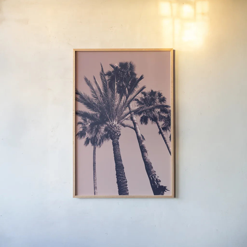 Pink Palms II by Deborah Revell. shown as a paper print in a natural frame. Available as a archival giclee rolled canvas, fine art paper, or poster print. SKU 94376h.
