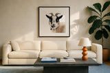 Pippa the Goat II by Deborah Revell. Displayed in a glass frame with matte in a clean modern living room. Available as an archival giclee rolled canvas, fine art paper, or poster print. SKU 96298a.