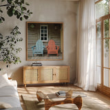 Porch Chairs by Deborah Revell. Shown in a natural wood frame in a cozy modern living room. Available as an archival giclee rolled canvas, fine art paper, or poster print. SKU 94578a.