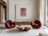 Purple Hydrangea on Book by Deborah Revell. Shown as extra-large giant wall art in a modern living room. Available as an archival giclee rolled canvas, fine art paper, or poster print. SKU 98516a.