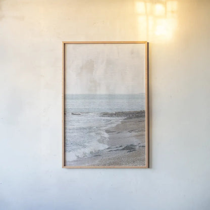 Rain on the Secret Beach by Deborah Revell. shown as a paper print in a natural frame. Available as a archival giclee rolled canvas, fine art paper, or poster print. SKU 94134h.