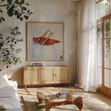 Red Grasshopper by Deborah Revell. Shown in a natural wood frame in a cozy modern living room. Available as an archival giclee rolled canvas, fine art paper, or poster print. SKU 91139a.