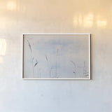 Reeds on the Ley III by Deborah Revell. shown as a paper print in a white frame. Available as a archival giclee rolled canvas, fine art paper, or poster print. SKU 91121i.