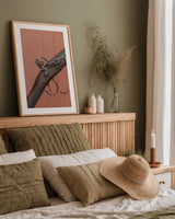 Rifle by Deborah Revell. shown as a paper print in a natural frame. Available as a archival giclee rolled canvas, fine art paper, or poster print. SKU 96607h.