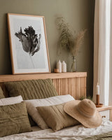 Sepia Tulip I by Deborah Revell. shown as a paper print in a natural frame. Available as a archival giclee rolled canvas, fine art paper, or poster print. SKU 93418h.