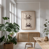 Shore and Fiddler Crab by Deborah Revell. shown as a print in a natural wood frame in a dining room. Available as a archival giclee rolled canvas, fine art paper, or poster print. SKU 95764h.