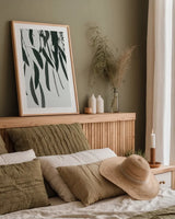 Simple Eucalyptus II by Deborah Revell. shown as a paper print in a natural frame. Available as a archival giclee rolled canvas, fine art paper, or poster print. SKU 102715h.