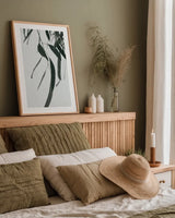 Simple Eucalyptus III by Deborah Revell. shown as a paper print in a natural frame. Available as a archival giclee rolled canvas, fine art paper, or poster print. SKU 102716h.