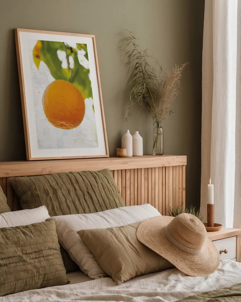 Single Orange by Deborah Revell. shown as a paper print in a natural frame. Available as a archival giclee rolled canvas, fine art paper, or poster print. SKU 94133h.