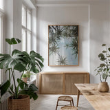 Spiral Palm I by Deborah Revell. shown as a print in a natural wood frame in a dining room. Available as a archival giclee rolled canvas, fine art paper, or poster print. SKU 104280h.