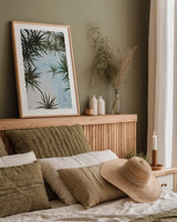 Spiral Palm I by Deborah Revell. shown as a paper print in a natural frame. Available as a archival giclee rolled canvas, fine art paper, or poster print. SKU 104280h.