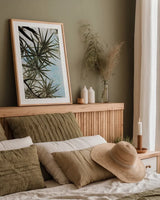 Spiral Palm II by Deborah Revell. shown as a paper print in a natural frame. Available as a archival giclee rolled canvas, fine art paper, or poster print. SKU 104281h.