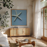Starfish I by Deborah Revell. Shown in a natural wood frame in a cozy modern living room. Available as an archival giclee rolled canvas, fine art paper, or poster print. SKU 96628a.