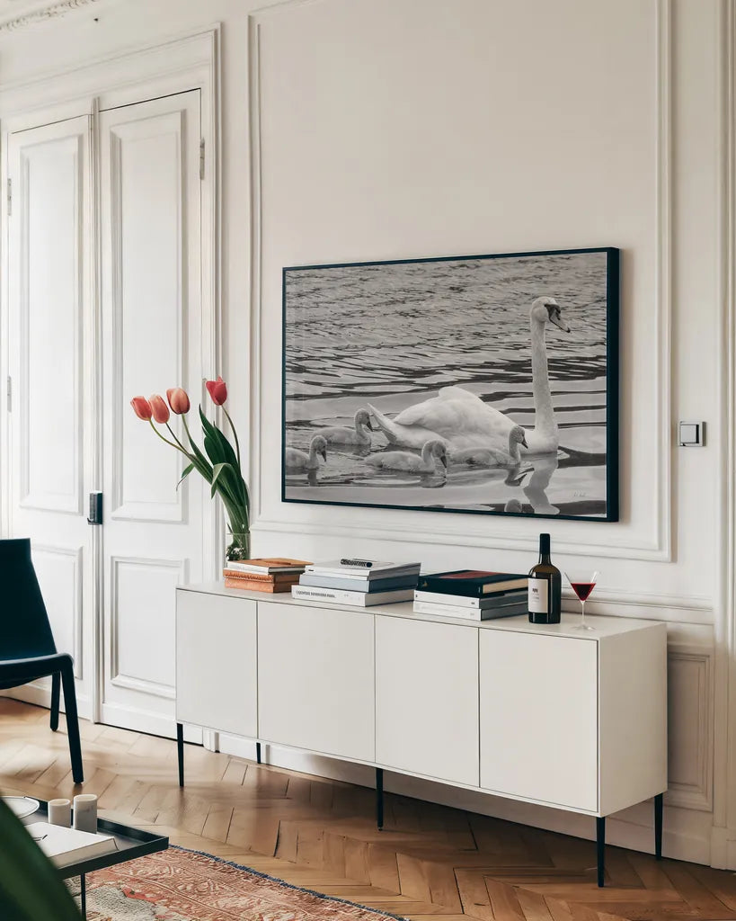Swan and Cygnets by Deborah Revell. shown as a framed stretched canvas in a living room above a console. Available as a archival giclee rolled canvas, fine art paper, or poster print. SKU 96816i.