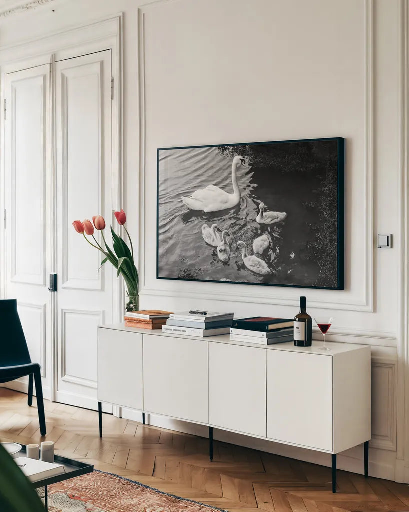 Swans on the Lake by Deborah Revell. shown as a framed stretched canvas in a living room above a console. Available as a archival giclee rolled canvas, fine art paper, or poster print. SKU 96818i.