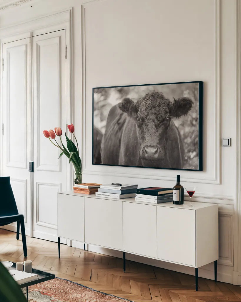 The Cow by Deborah Revell. shown as a framed stretched canvas in a living room above a console. Available as a archival giclee rolled canvas, fine art paper, or poster print. SKU 94287i.