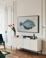 The Plaice by Deborah Revell. shown as a framed stretched canvas in a living room above a console. Available as a archival giclee rolled canvas, fine art paper, or poster print. SKU 91180i.