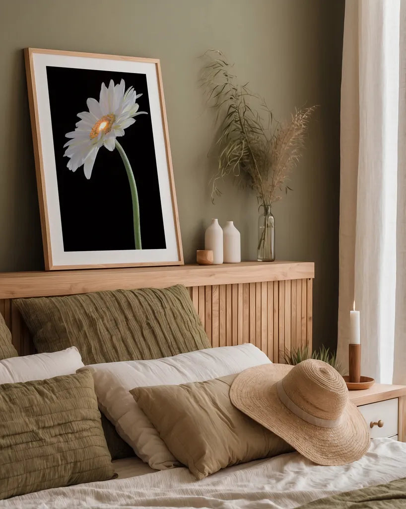White Gerber Light by Deborah Revell. shown as a paper print in a natural frame. Available as a archival giclee rolled canvas, fine art paper, or poster print. SKU 95332h.