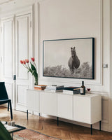 Wild Dartmoor Pony by Deborah Revell. shown as a framed stretched canvas in a living room above a console. Available as a archival giclee rolled canvas, fine art paper, or poster print. SKU 94289i.