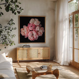 Coral Peonies III by Debra Van Swearingen. Shown in a natural wood frame in a cozy modern living room. Available as an archival giclee rolled canvas, fine art paper, or poster print. SKU 86252a.