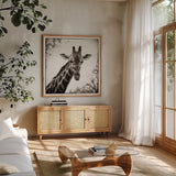 Giraffe I by Debra Van Swearingen. Shown in a natural wood frame in a cozy modern living room. Available as an archival giclee rolled canvas, fine art paper, or poster print. SKU 17949a.