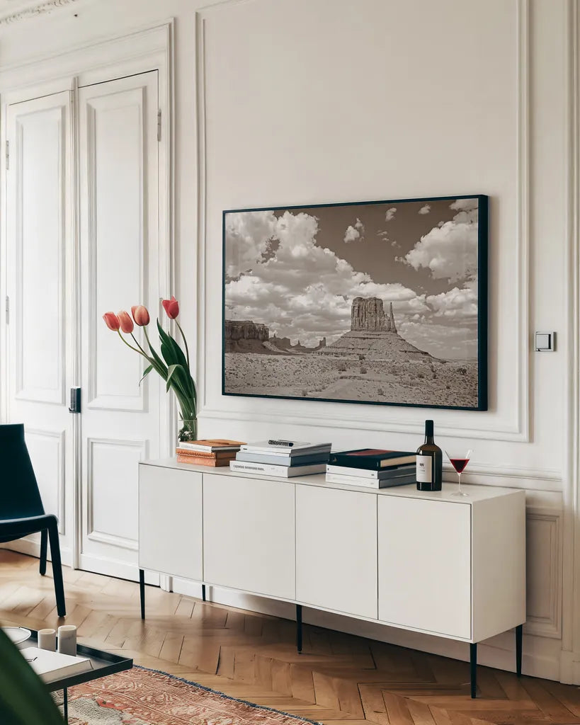 Monument Valley II Sepia by Debra Van Swearingen. shown as a framed stretched canvas in a living room above a console. Available as a archival giclee rolled canvas, fine art paper, or poster print. SKU 81270i.