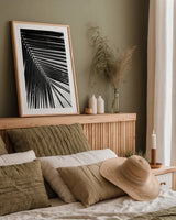 Palm Frond II by Debra Van Swearingen. shown as a paper print in a natural frame. Available as a archival giclee rolled canvas, fine art paper, or poster print. SKU 42489h.