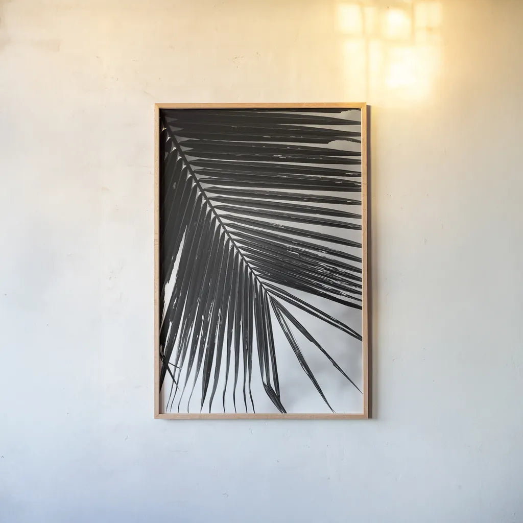 Palm Frond II by Debra Van Swearingen. shown as a paper print in a natural frame. Available as a archival giclee rolled canvas, fine art paper, or poster print. SKU 42489h.
