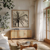 Palm Tree Sepia III by Debra Van Swearingen. Shown in a natural wood frame in a cozy modern living room. Available as an archival giclee rolled canvas, fine art paper, or poster print. SKU 42501a.